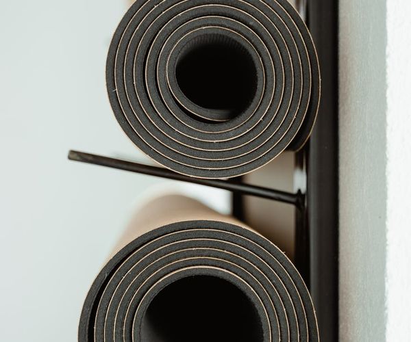 Bright and colorful yoga studio interior with mats rolled out for a class.